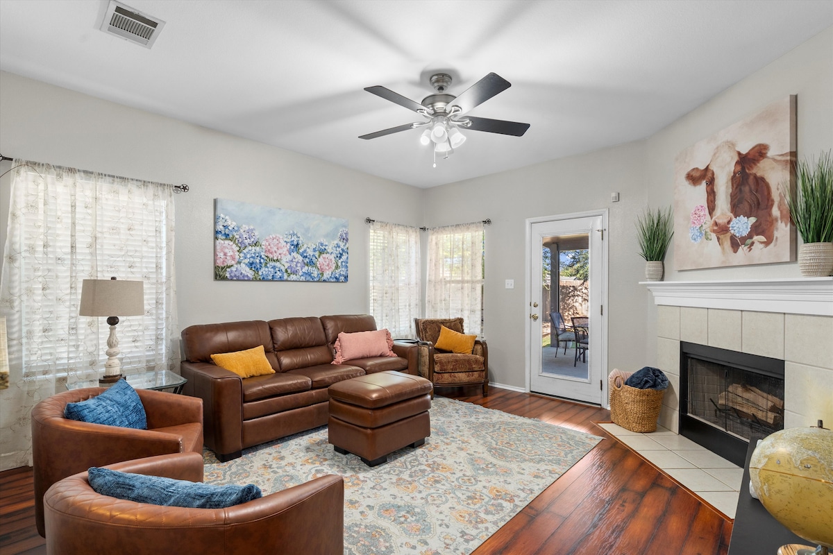 Backyard, Games & Grill living room with leather seating and fireplace