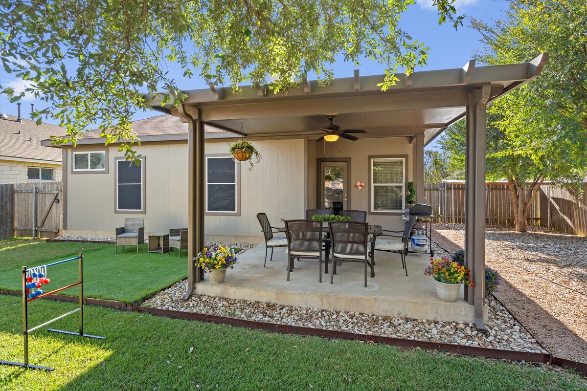 Backyard, Games & Grill shaded patio facing the lawn and ladder golf