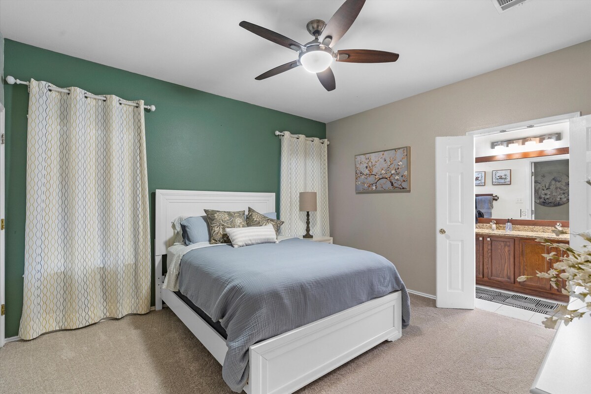 Backyard, Games & Grill primary bedroom with queen bed and ensuite