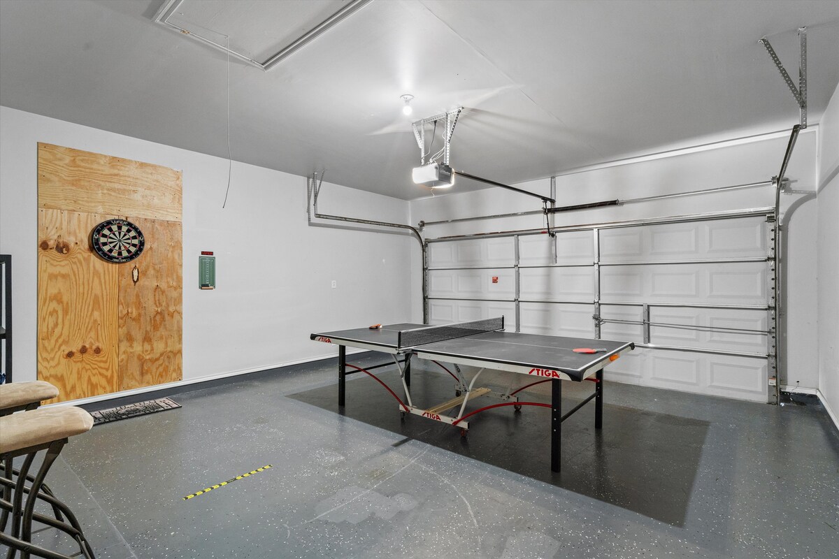 Backyard, Games & Grill garage with ping pong table and dartboard