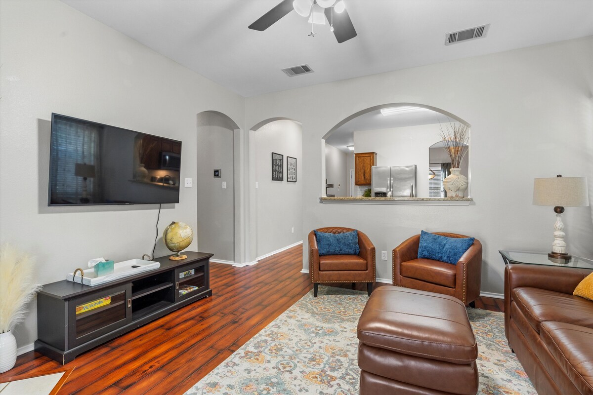 Backyard, Games & Grill living room with wall-mounted TV