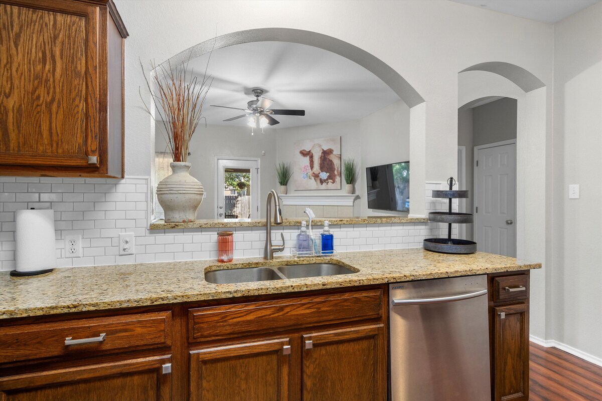 Backyard, Games & Grill kitchen sink looking through the arch to the living room
